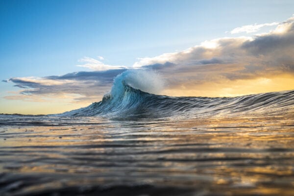 Colourful wave peaking into a flare with sunrise storm