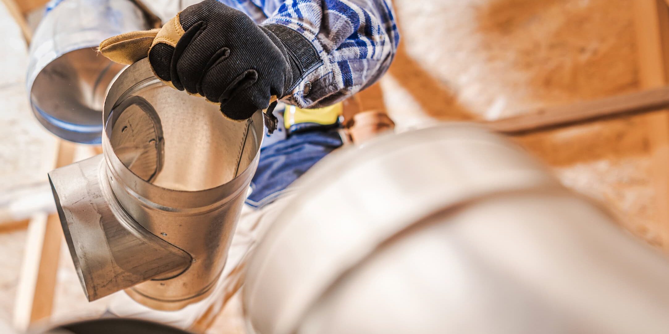 Close Up Of HVAC Worker Fitting Pipe Connections Of Air Ventilation System.